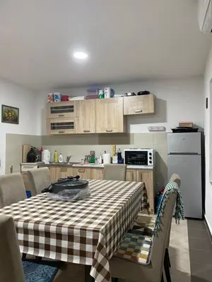 a kitchen with a table with a checkered table cloth at Honey Home in Podgorica