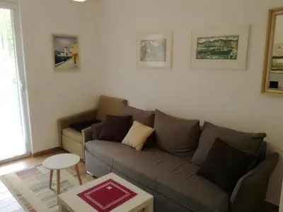 a living room with a couch and a table at Apartmani Stanislav in Petrovac na Moru