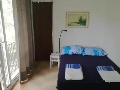 a bedroom with a bed with two pillows on it at Apartmani Stanislav in Petrovac na Moru