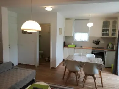 a kitchen and dining room with a table and chairs at Apartmani Stanislav in Petrovac na Moru