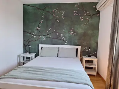 a bedroom with a bed with a tree mural at Apartment Jasmina in Krimovice