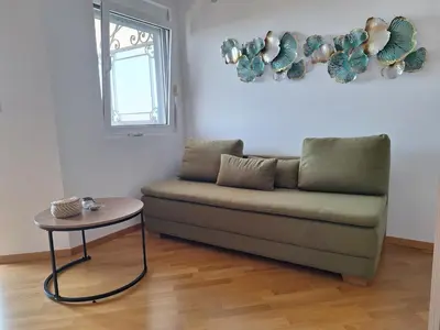 a living room with a couch and a table at Apartment Jasmina in Krimovice
