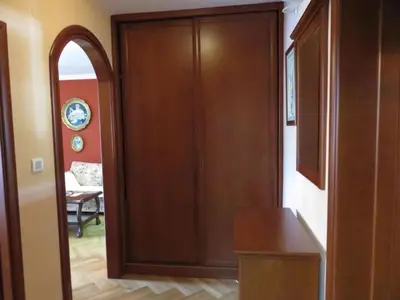 a wooden door in a room with a hallway at Apartman Maja in Sveti Stefan