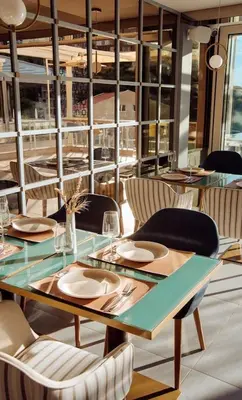 a dining room with a table and chairs at Status-M Apartments 112 in Becici