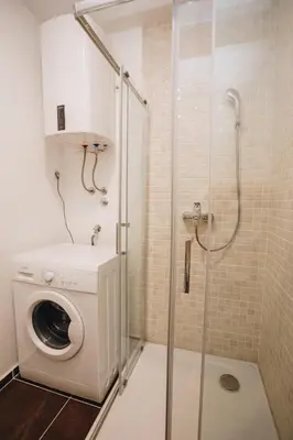 a washing machine in a bathroom with a shower at Status-M Apartments 112 in Becici