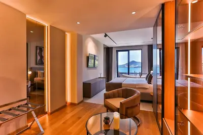 a hotel room with a bed and a view of the ocean at Hotel kingStone Budva in Budva