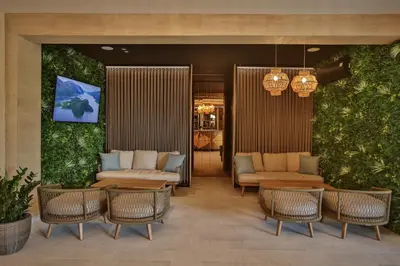 a lobby with chairs and tables and plants at Hotel kingStone Budva in Budva