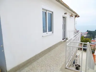 a balcony of a white building with a window at Apartment Batricevic in Ulcinj