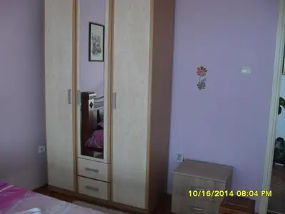 a wooden cabinet with a mirror in a bedroom at Apartment Batricevic in Ulcinj