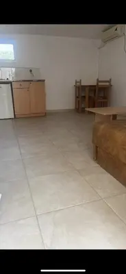 a large empty room with a table and a couch at Babulje in Ulcinj