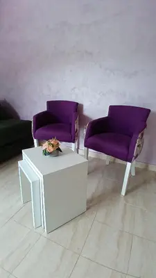 two purple chairs and a table in a room at MarBis Apartmani near the sea in Utjeha