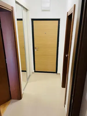 an empty hallway with two doors in a building at RB De lux apartment in Podgorica