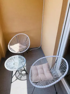 two chairs and two tables with a pillow on them at RB De lux apartment in Podgorica