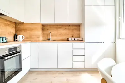 a kitchen with white cabinets and a sink at The Riverscape in Podgorica