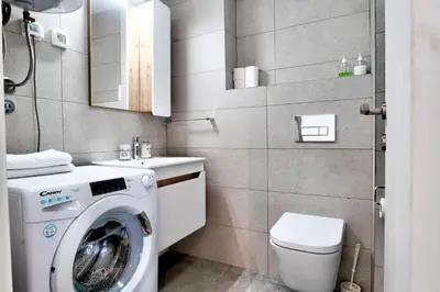 a small bathroom with a washing machine in it at The Riverscape in Podgorica