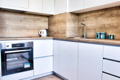 a kitchen with white cabinets and a sink at The Riverscape in Podgorica