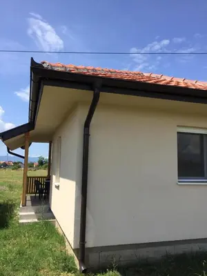 a small white house with a red roof at M&A Montenegro Apartmani in Golubovci