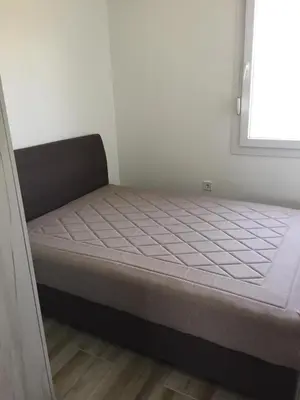 a small bed in a room with a window at M&A Montenegro Apartmani in Golubovci