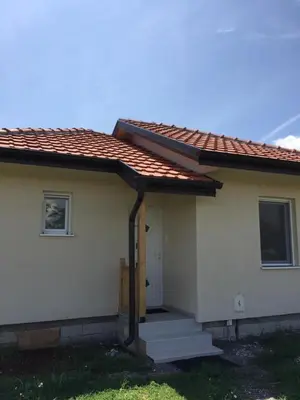 a small white house with a door and stairs at M&A Montenegro Apartmani in Golubovci