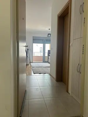 a hallway with a door and a tile floor at Smakovic Apartments in Ulcinj