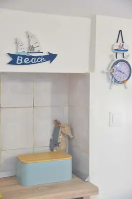 a room with a bench and a clock on a wall at Apartman 3 in Budva