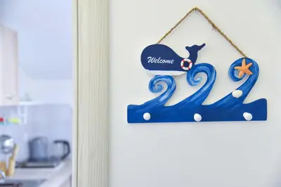 a sign for a kitchen with a whale and a starfish at Apartman 3 in Budva