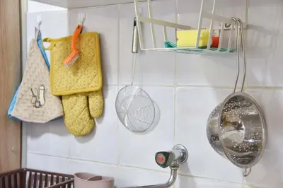 a kitchen with a sink with a fan and towels at Apartman 3 in Budva