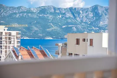 a view of the ocean and mountains from a building at Apartman 3 in Budva