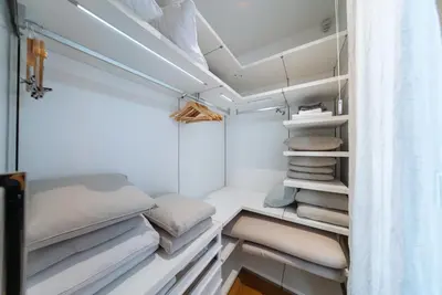 a walk in closet with white shelves and pillows at Luxury Waterfront Villa at Dukly Gardens in Budva