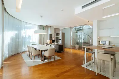 a kitchen and dining room with a table and chairs at Luxury Waterfront Villa at Dukly Gardens in Budva