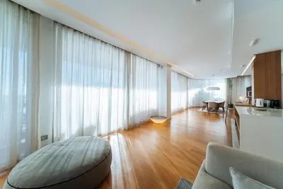 a living room with a couch and a large window at Luxury Waterfront Villa at Dukly Gardens in Budva