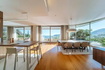 a dining room with a table and chairs with a view at Luxury Waterfront Villa at Dukly Gardens in Budva