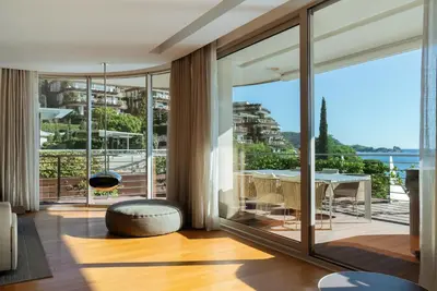 a living room with a view of a balcony at Luxury Waterfront Villa at Dukly Gardens in Budva