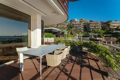 a table and chairs on the balcony of a house at Luxury Waterfront Villa at Dukly Gardens in Budva