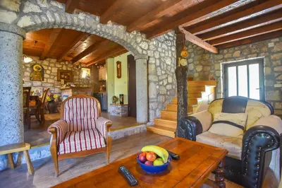 a living room with a couch and a table at Holiday Home Dapcevic in Budva