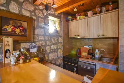 a kitchen with a wooden counter top in a room at Holiday Home Dapcevic in Budva