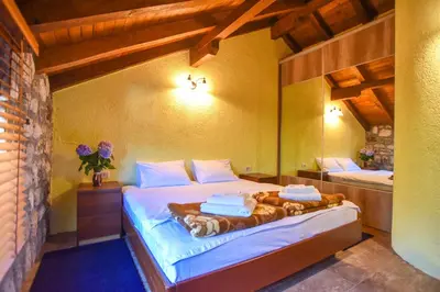 a bedroom with a bed with towels on it at Holiday Home Dapcevic in Budva