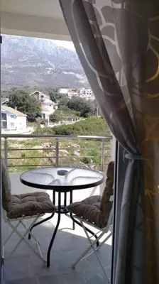 a table and two chairs on a balcony with a view at Студия для отдыха или проживания in Dobra Voda