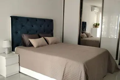 a bedroom with a large bed and a large mirror at Студия для отдыха или проживания in Dobra Voda