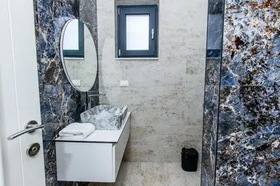 a bathroom with a sink and a mirror at Lira Suites in Donji Štoj