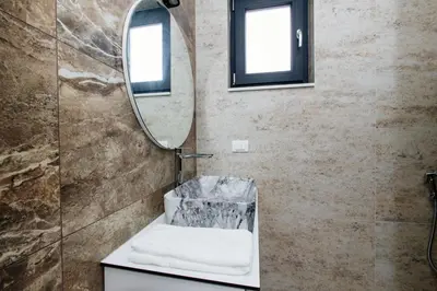 a bathroom with a sink and a mirror at Lira Suites in Donji Štoj