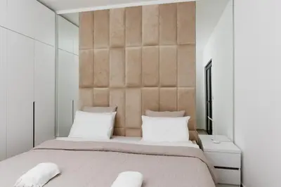 a bedroom with a large bed with white pillows at Lira Suites in Donji Štoj