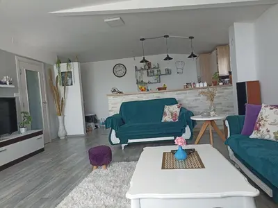 a living room with a green couch and a table at Perfect VIEW in Ulcinj