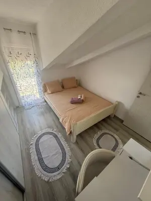 a small bedroom with a bed and a window at Perfect VIEW in Ulcinj