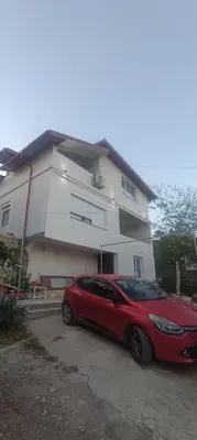 a red car parked in front of a house at Perfect VIEW in Ulcinj
