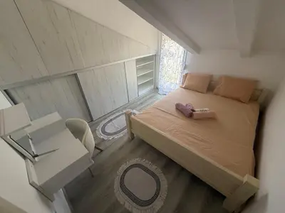 a small bedroom with a bed and a table at Perfect VIEW in Ulcinj