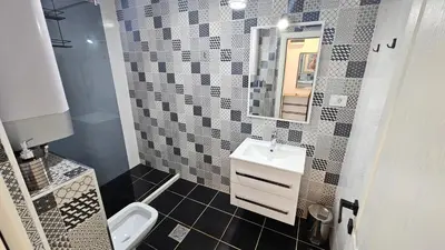a bathroom with a sink and a toilet and a mirror at Apartmani Lime in Petrovac na Moru