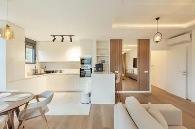 a living room and kitchen with a couch and a table at Lux Grand Apartment Kotor in Kotor