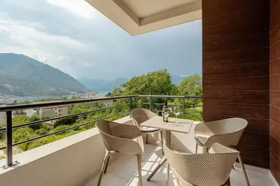 a balcony with chairs and a table with a view at Lux Grand Apartment Kotor in Kotor