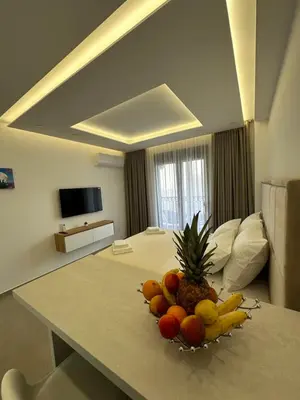 a bowl of fruit on a table in a hotel room at Studio Apartman Dalia in Budva